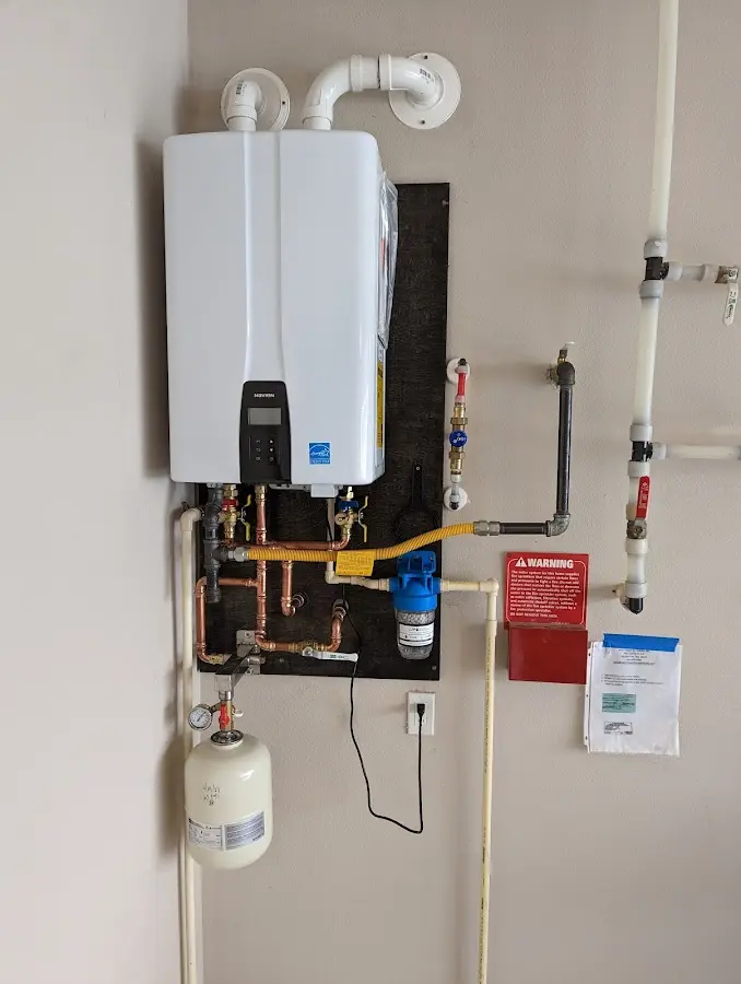 Professional plumber installing copper piping in a Broken Bow home